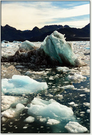 Blue And Turquoise Color Ice Of Glacier Face And Reflections In