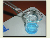 The solution of sodium carbonate is being added to the solution of copper(II) sulfate